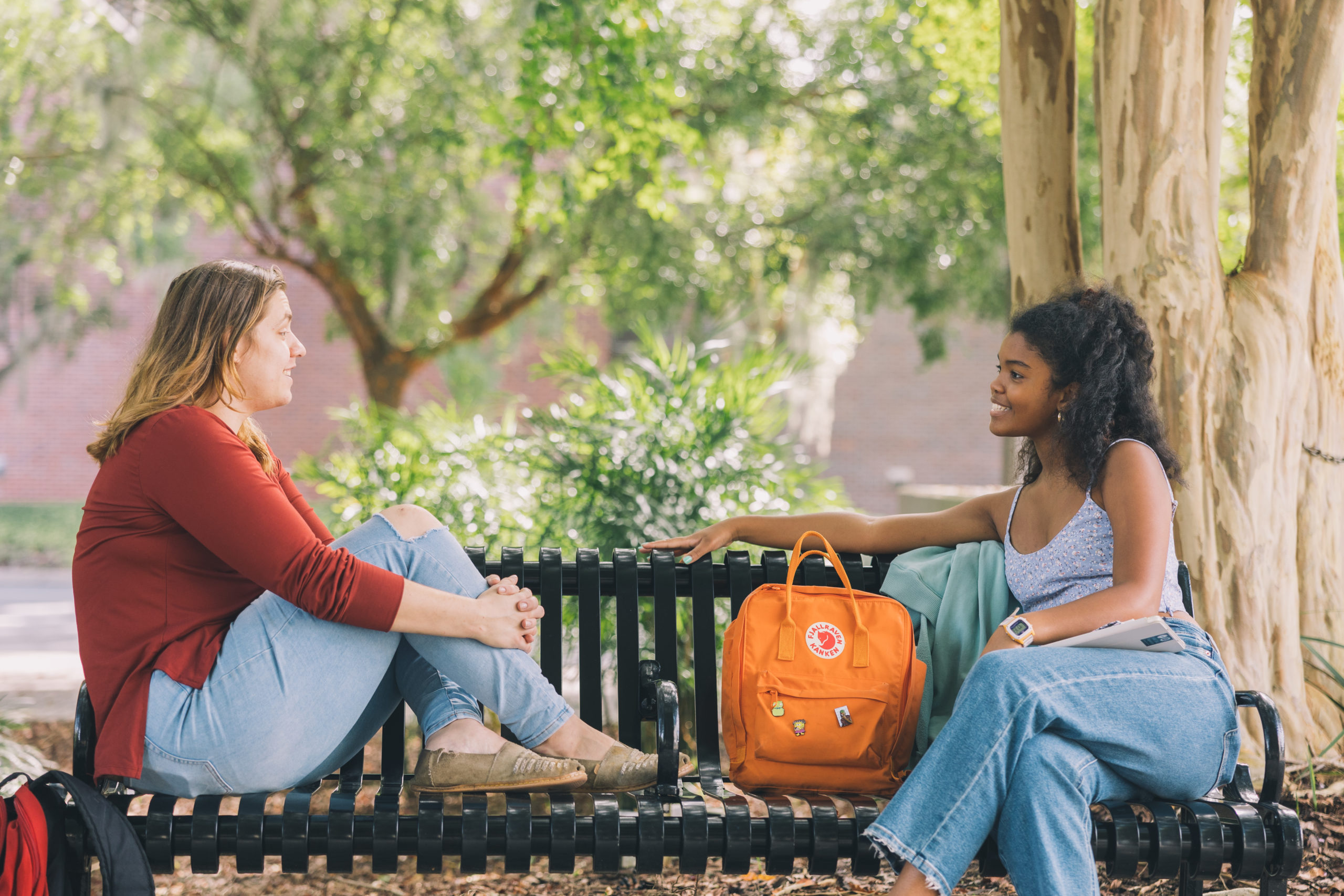 Students using equitable language on a bench