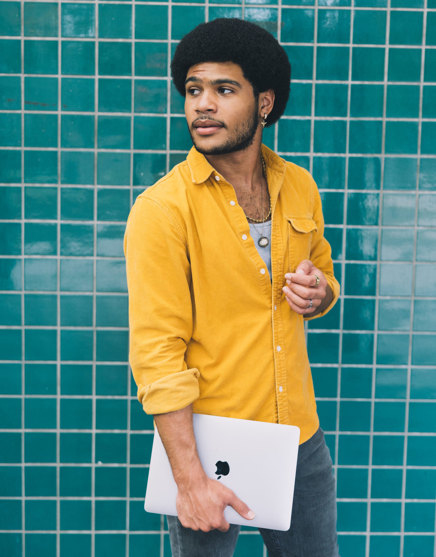 Student with laptop on campus. Equitable digital learning.